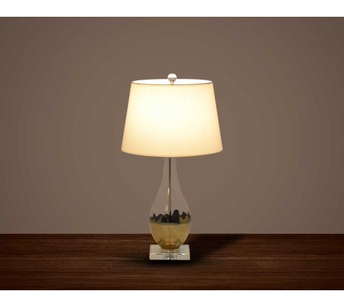 Table lamp with metallic gold and glass decorative base with translucent fabric shade.