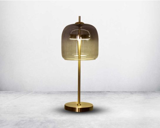 This mid-century modern table lamp features an elegant matt gold metal base that gracefully holds atop its grey glass shade.