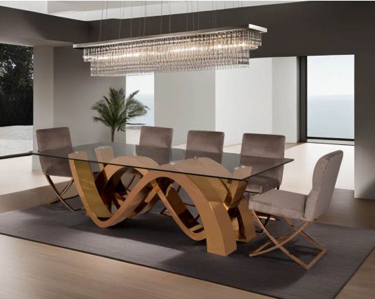 This 8-seater dining table with clear tempered glass top comes with an artful abstract wave-shaped concave design finished in a shiny rose gold plated stainless steel base in rose gold finish Dining chair upholstered in fabric with rose gold plated stainl