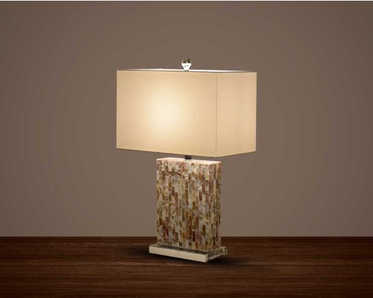 Table lamp in a stone mosaic pattern with a gold metal base and translucent fabric shade in an earthy natural design.