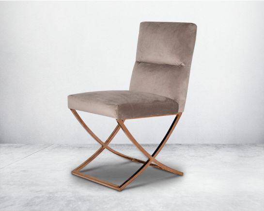 Dining chair upholstered in fabric with rose gold plated stainless steel legs in a cross design.