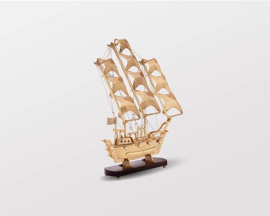 Decorative ship in antique gold and sheesham wood base.