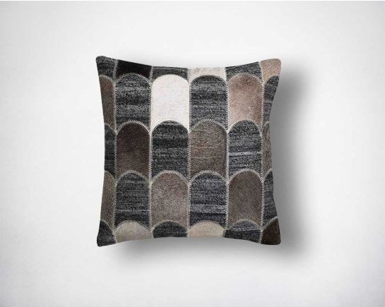 Grey, brown and black cut-out fabric and leather hair on the cushion.