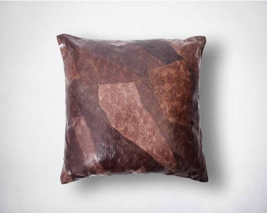 Patched suede leather cushion.
