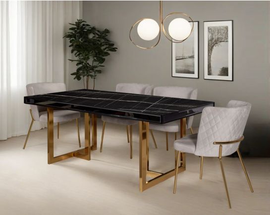 This 6-seater dining table comes with a black imitation Italian marble top & mirror frame/border with a stainless steel gold finished base in modern design with chair criss-cross stitch padded fabric in gold finish stainless steel legs in contemporary des